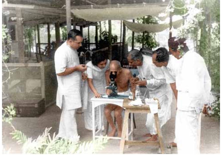 Doctors showing to Mahatma Gandhi hookworm ova under microscope in Bombay, May 1944 (Photo IJMR)